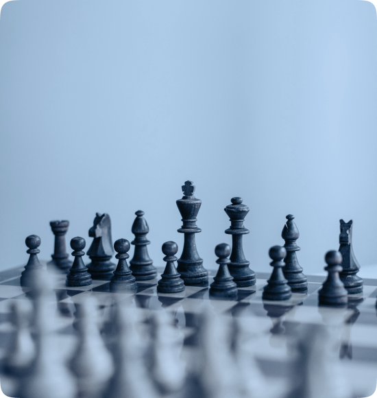 Blue chess pieces on a board, representing strategy